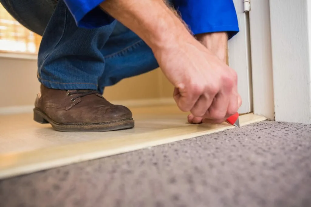 Fremont Floor - Floor Water Damage 1 flooring services doing finishing touch to carpet installation